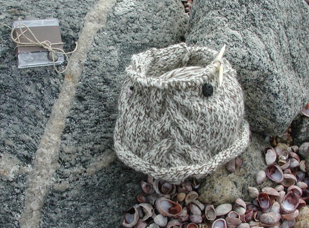 Stone stitch markers at Long Island Sound glacial rubble deposits. Moo Dog Knits WIP with Intraclast stitch markers - photo shoot at Long Island Sound, Connecticut.