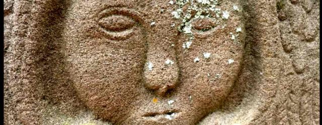 Stone face carving with lichen. Photo © Moo Dog Knits